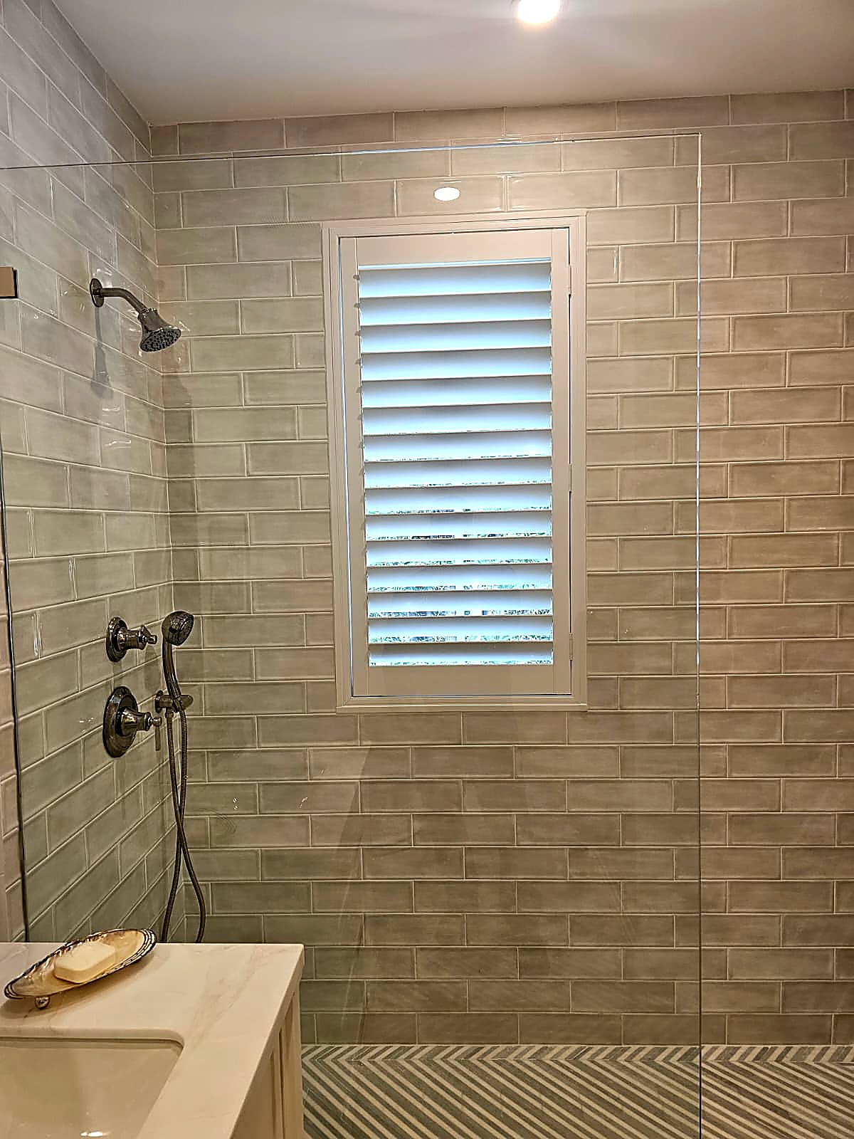 Plantation shutter in shower bathroom